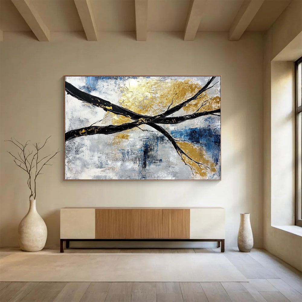 Abstract painting featuring black and white branches with gold leaf accents against a serene blue sky background.SC367