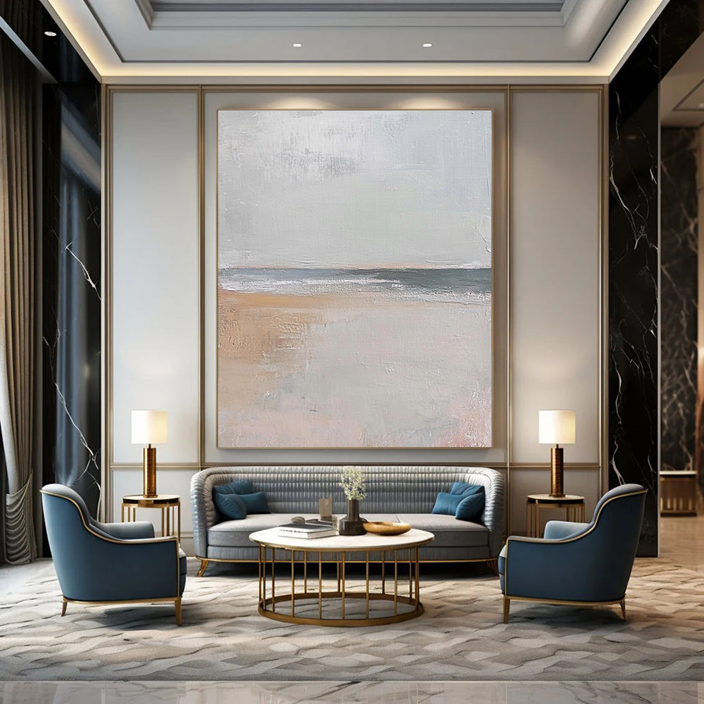 Large abstract painting in muted beige and gray tones featuring gentle brushstrokes of serene coastal scenery with hints of sandy textures and flying seagulls.STSC016