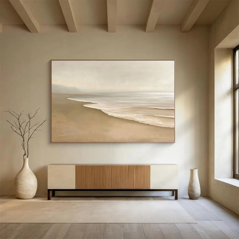 Large abstract painting featuring a serene beach with beige and white tones capturing gentle waves and soft sand in a tranquil setting.SC424