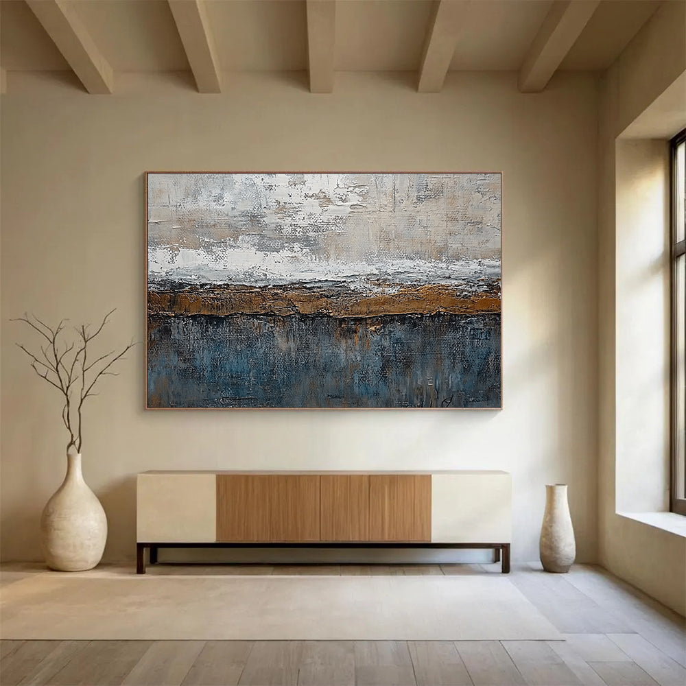 Large abstract painting features textured layers of grey, brown, blue, and bronze with painterly strokes and metal accents creating an artistic landscape.SC174