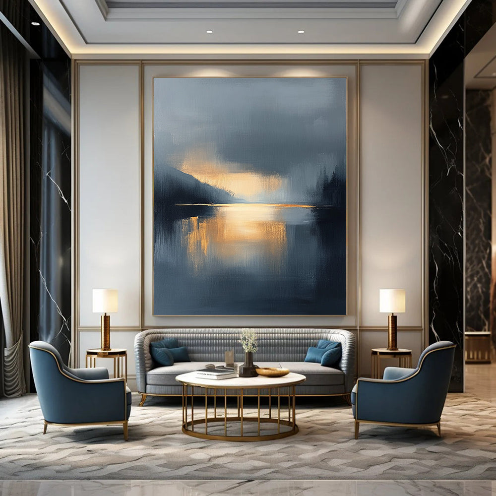Large abstract oil painting featuring a lake and sky with navy blue and gold tones atmospheric clouds and reflections in calm waters.STSC167