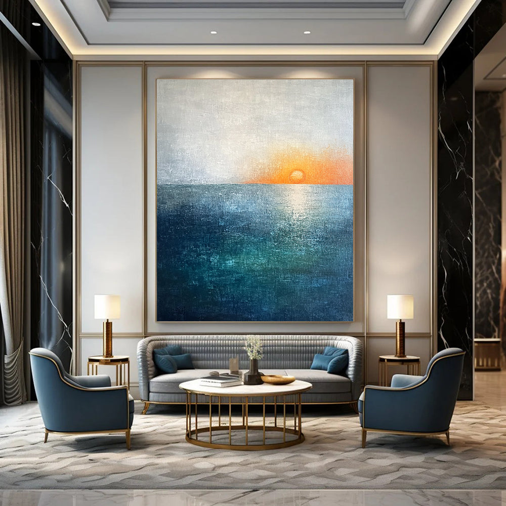 Large abstract painting featuring a soft sky blue and teal gradient with a grey expanse and a small orange sun setting on the horizon.STSC094
