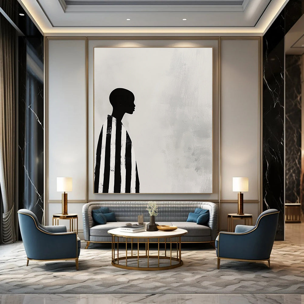 A large abstract painting featuring a striking black and white profile of an African woman in striped robes against a soft gray background.STSC1079