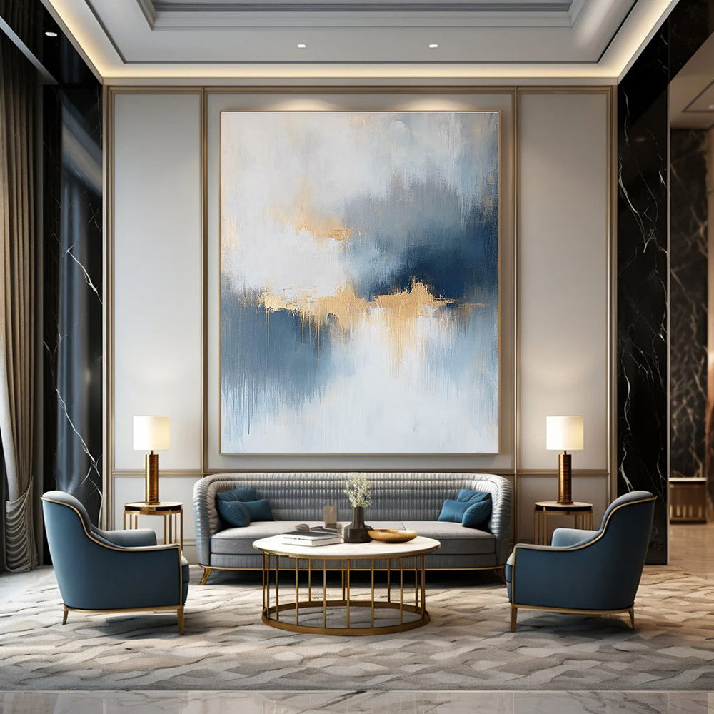 Large abstract painting featuring atmospheric clouds in soft blue gray and white tones with gold and silver accents and delicate textures.STSC386