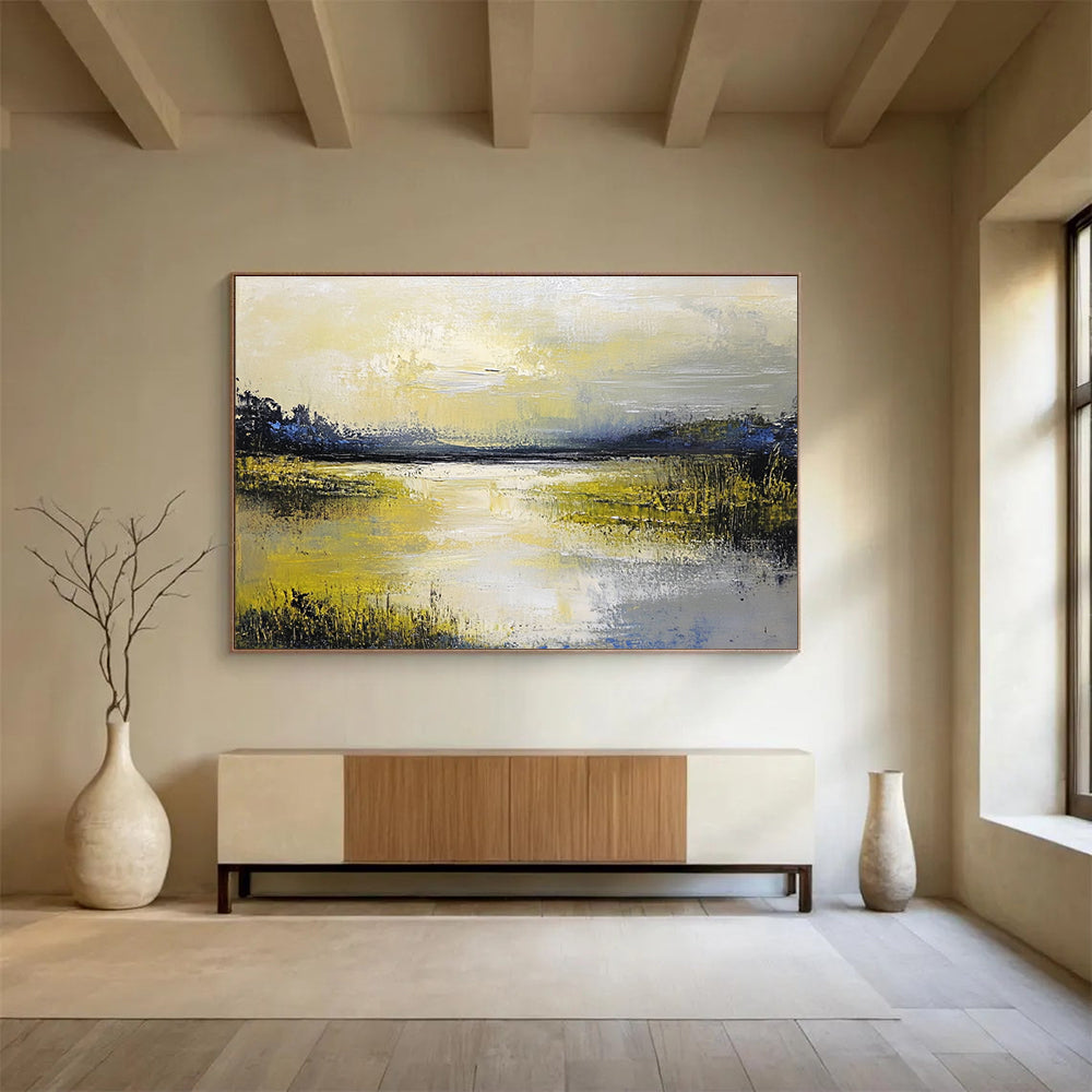 Large abstract painting featuring a serene lake and sky in soft yellow green blue and gray tones with thick textured paint.SC078