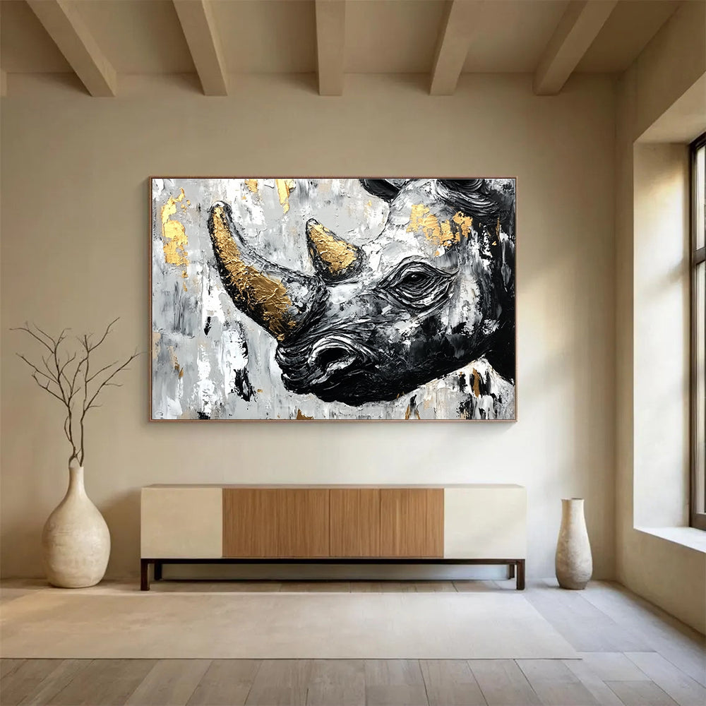 Abstract painting of an African rhinoceros in black and white with gold accents and textured strokes on a neutral background.SC151