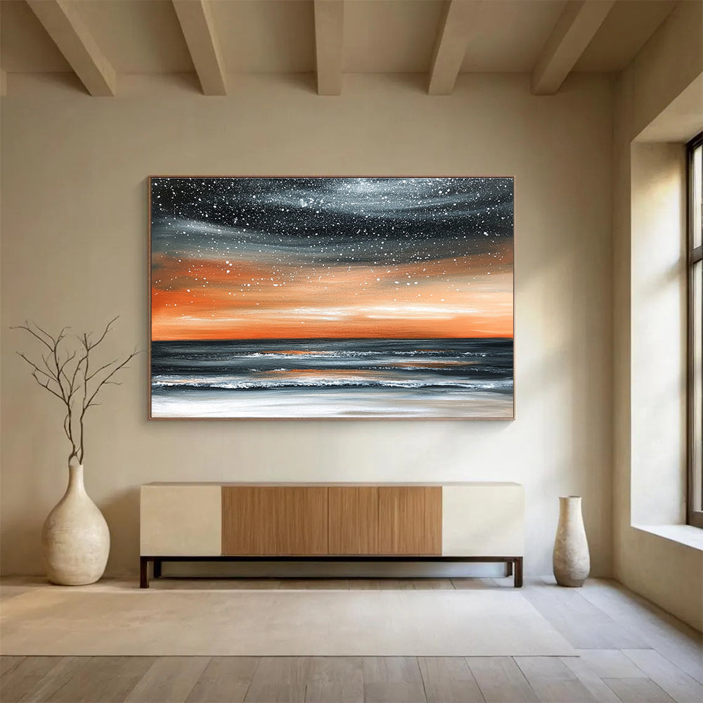 Large abstract painting of the ocean at night featuring an orange gray sky and starry snowfall over a muted water surface.SC130