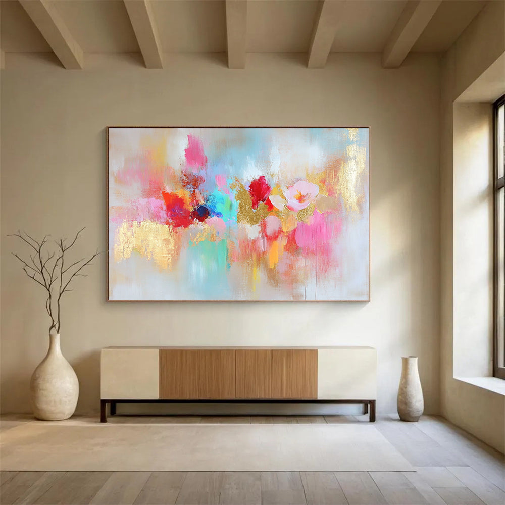 Large abstract painting with vibrant colors and gold leaf accents symbolizing happiness creativity and hope on a soft textured white background.SC264