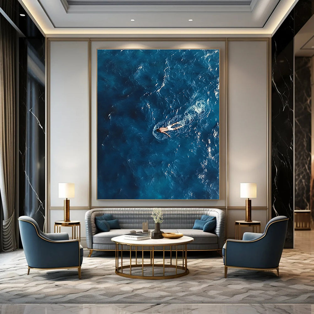 Large abstract painting depicting a solitary man in deep blue ocean waves wearing white swim trunks evoking solitude and calmness amidst chaos.STSC1057