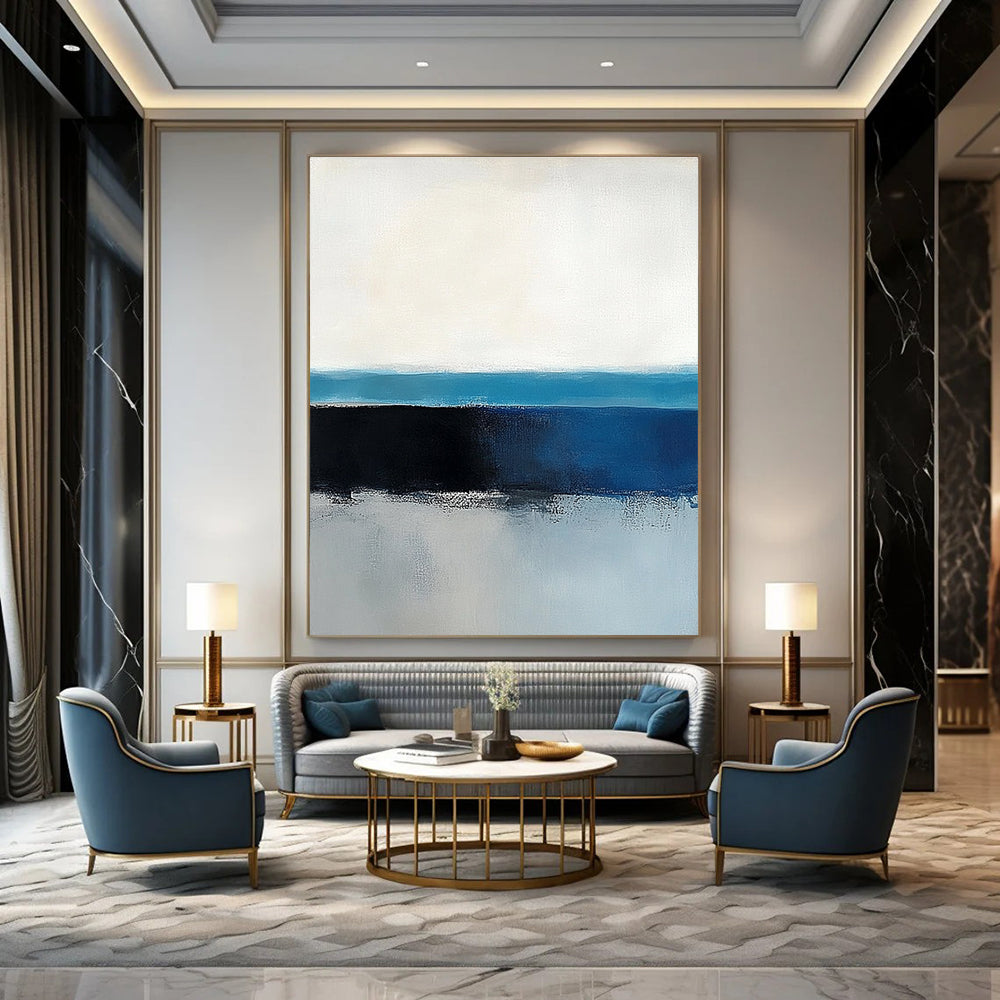 Large abstract painting of the ocean horizon featuring blue and gray tones in a minimalist style with neutral colors.STSC342