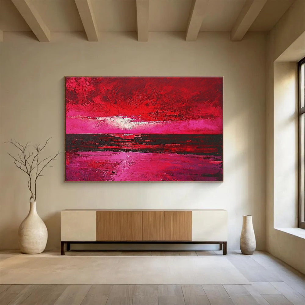 Large abstract painting depicting a red sky over the sea with hues of pink and crimson capturing the beauty of a sunset.SC273
