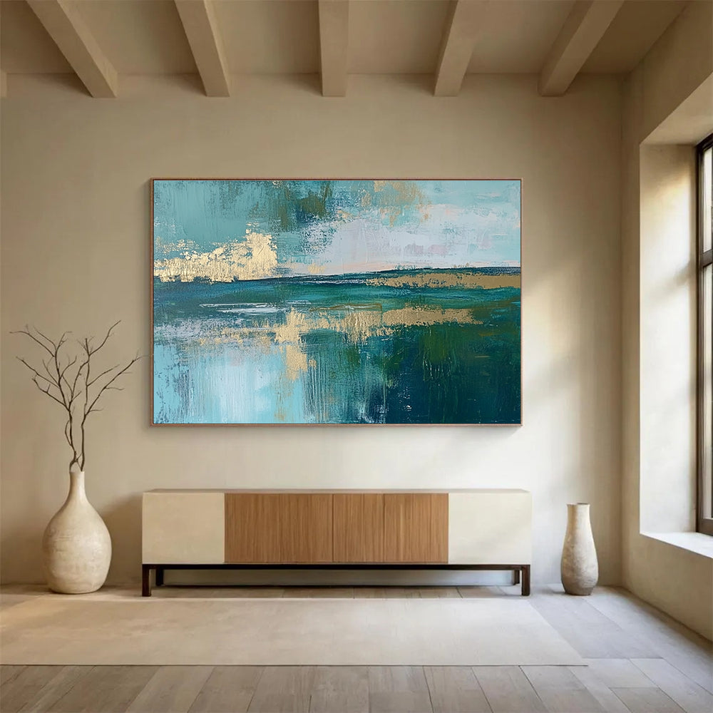 Large abstract painting featuring a serene lake, vibrant green fields, light blue sky, and elegant gold foil accents.SC115