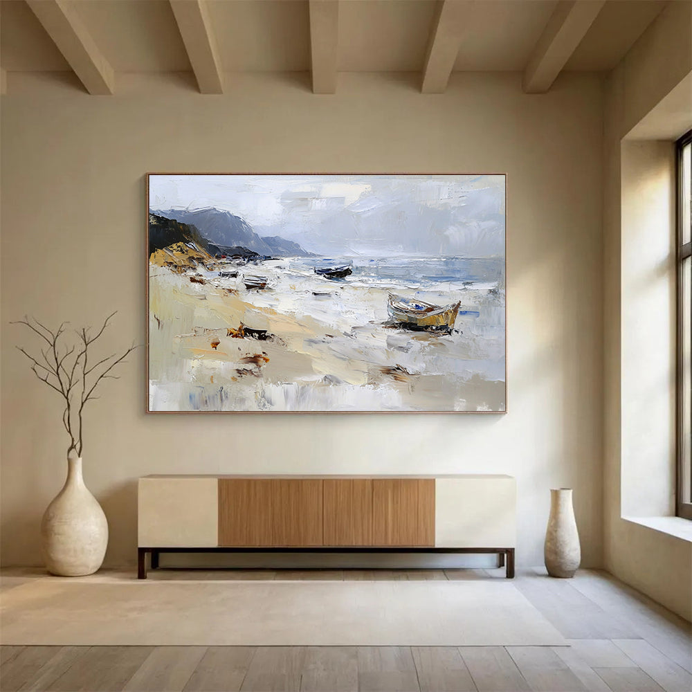 Large abstract oil painting of a beach with loose brush strokes featuring white gray and brown colors and visible sea spray and mountains in the background.SC605