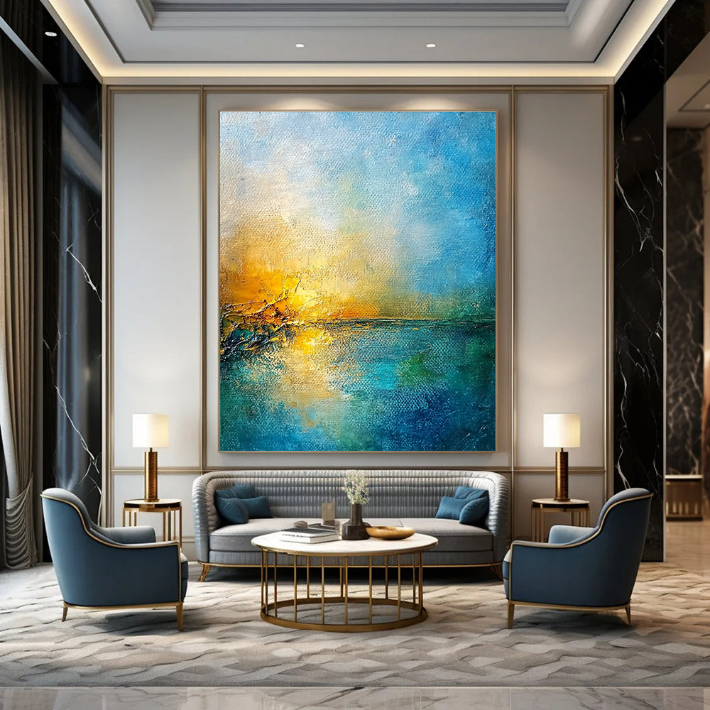 Large abstract painting of a golden sunset over a blue sea featuring textured canvas and rustic-core style nature-inspired colors.STSC165