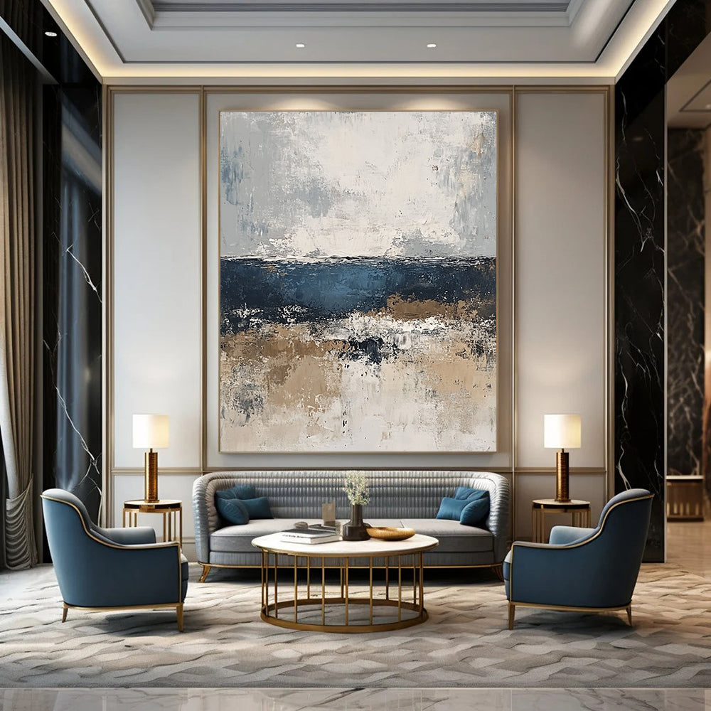 Large abstract painting of the sea in gray and blue tones with accents of beige brown and white for a serene artistic touch.STSC343