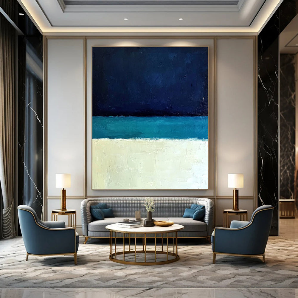 Large abstract painting featuring a minimalist ocean scene with blue tones white sand beach and a dark sky in Rothko style.STSC884