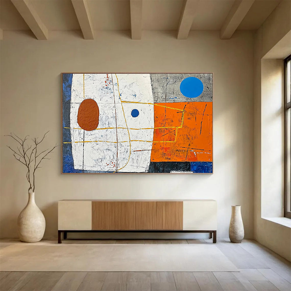 A large abstract painting featuring white squares orange and blue shapes yellow lines a small brown oval and a blue dot on a vibrant orange and dark grey background.SC376