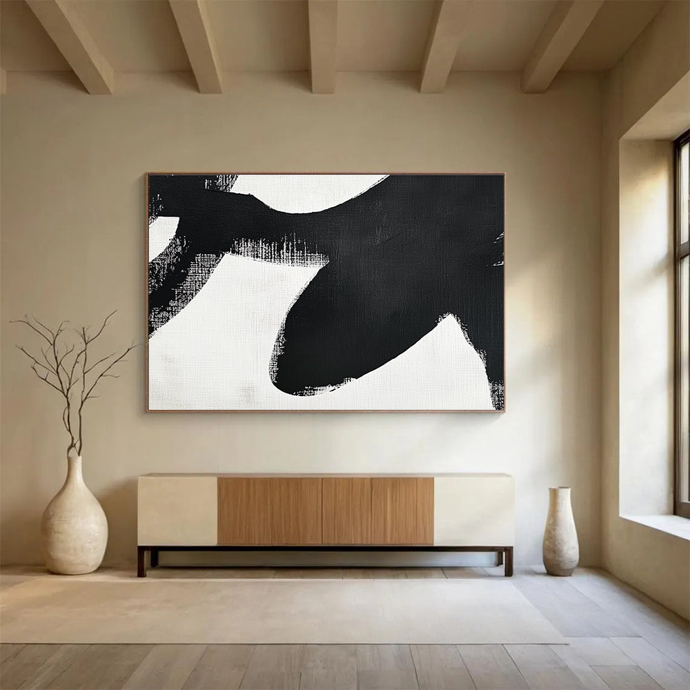 Large abstract painting in black and white featuring simple shapes and broad brush strokes inspired by an orca's tail flippers.SC016