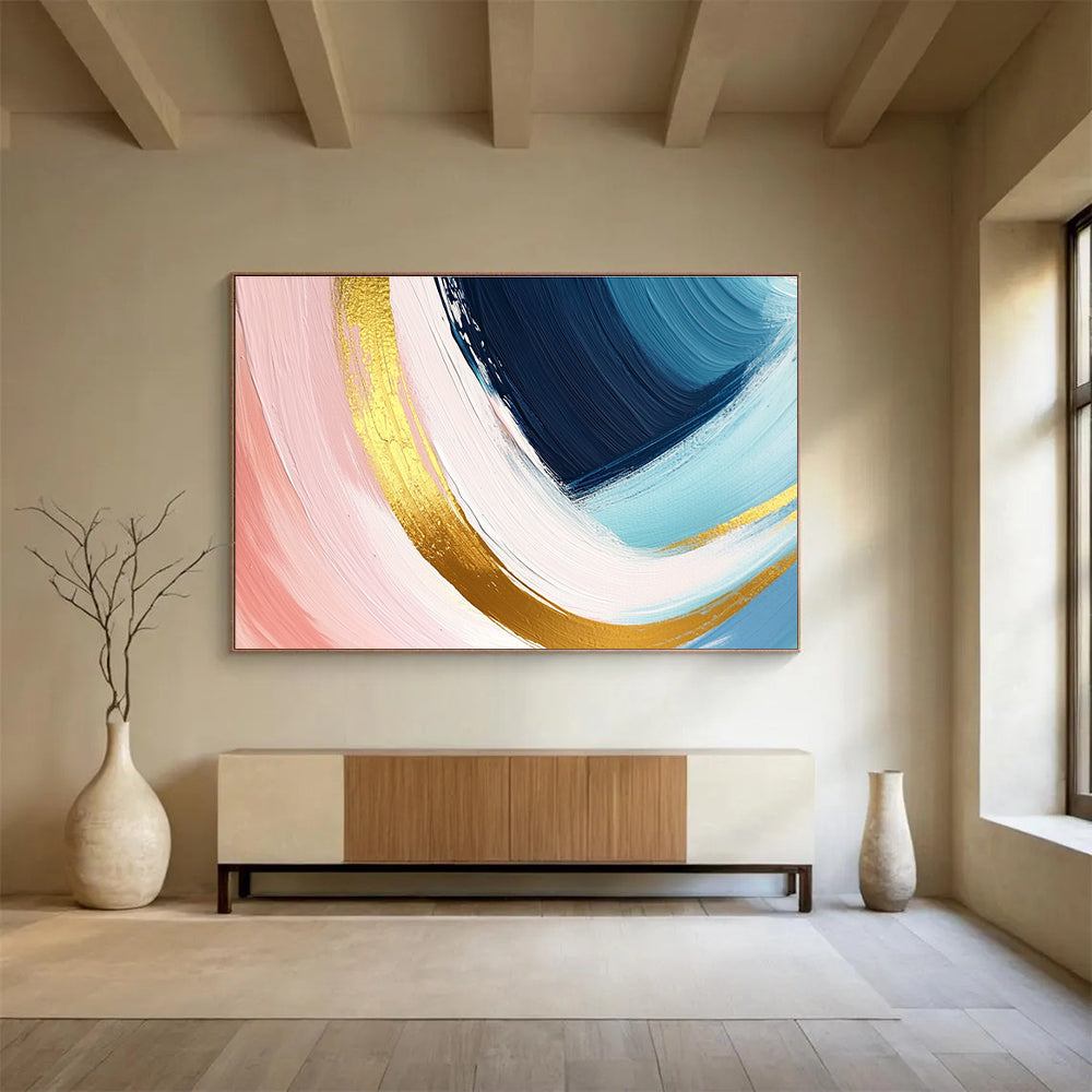 A large abstract painting in pastel pink blue and yellow with dynamic brushstrokes and gold outlines evoking joy and warmth.SC443