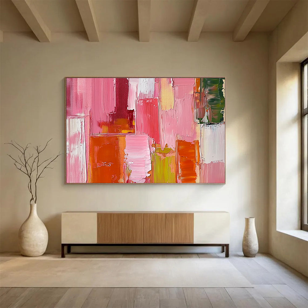 Large abstract oil painting featuring a pink orange and red cityscape with thick brush strokes and a soft impressionist style.SC118