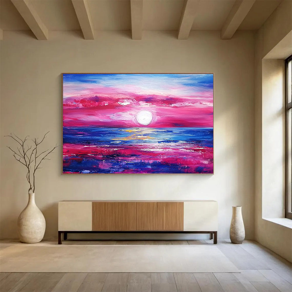 A large abstract painting featuring a pink and blue sunset over the ocean with purple and red clouds by artist Anna Bocek.SC537