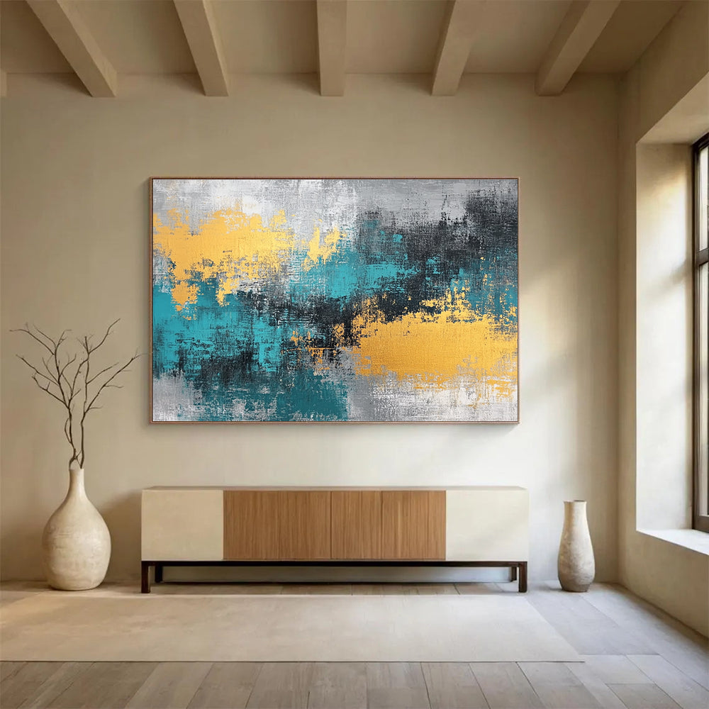 Large abstract painting featuring teal, grey, and gold hues that add a vibrant touch to any space.SC260