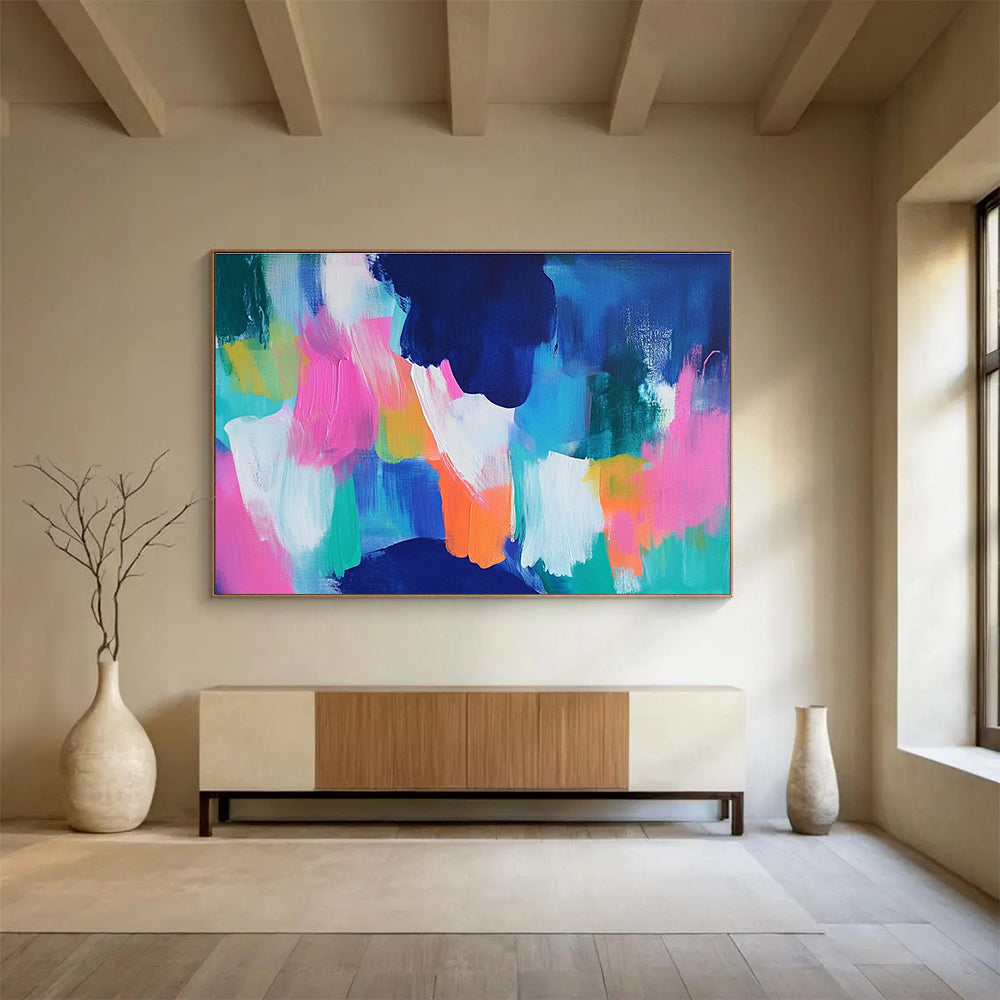 A large abstract painting with bold blue and pink backgrounds and bright orange, green, and turquoise foregrounds, conveying energy and movement.SC562
