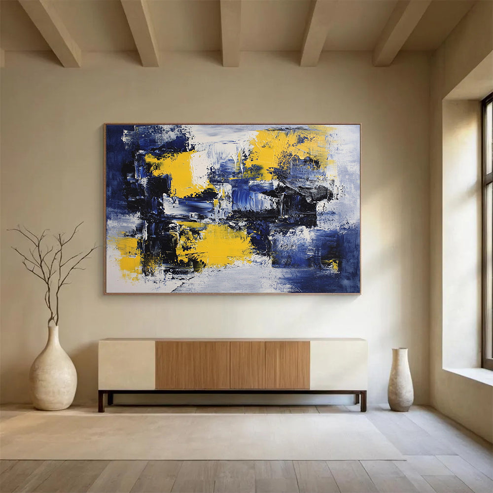 Large abstract painting featuring deep blue, white, and yellow accents with impressionist brush strokes on canvas ideal for modern wall decor.SC031