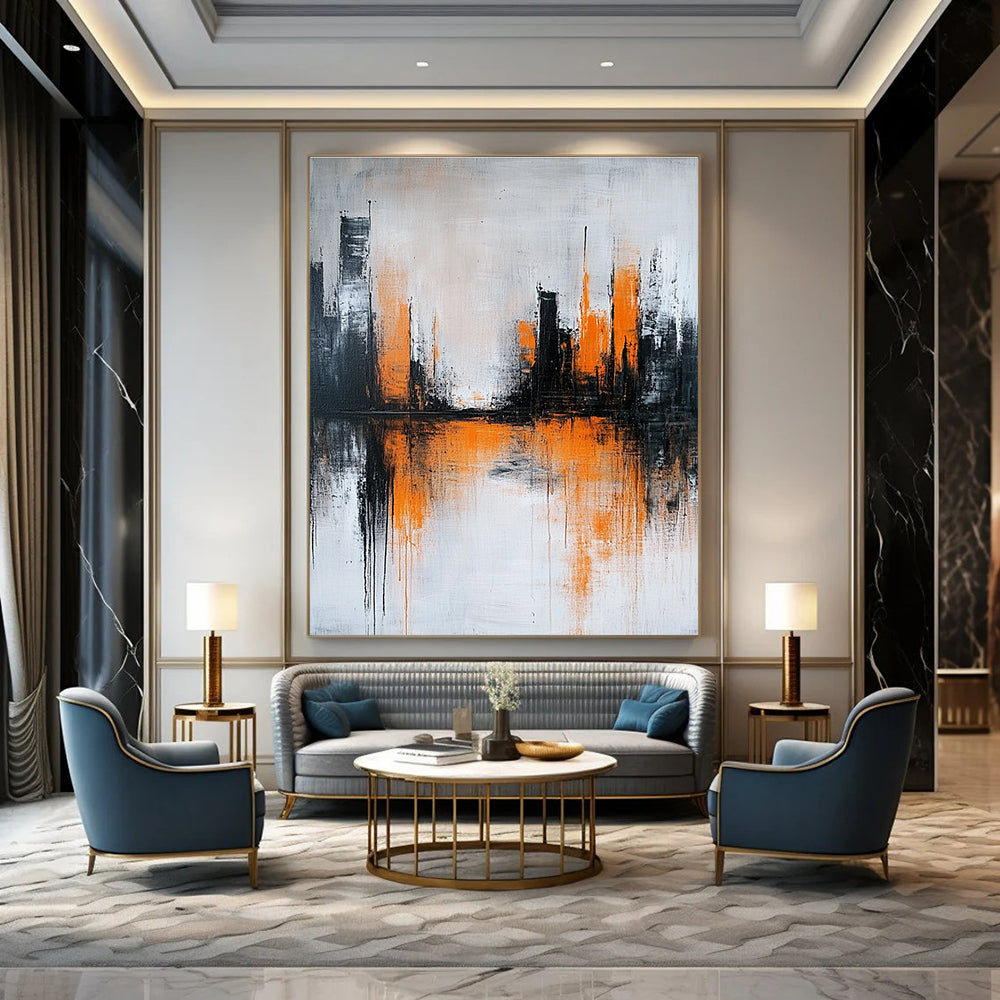 Large abstract painting featuring gray and white background with orange brushstrokes and urban landscape silhouette reflecting on water surface.STSC225