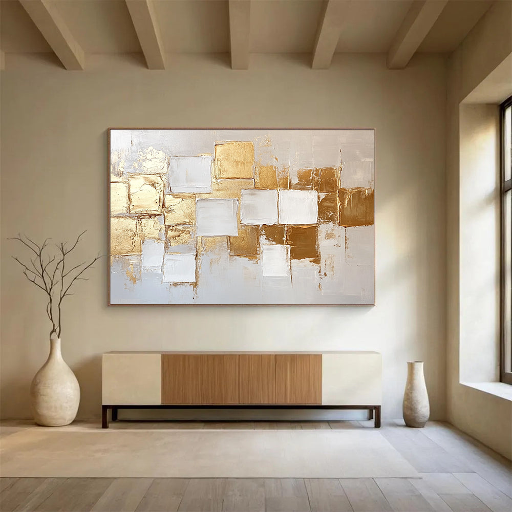 Large abstract painting in white and gold featuring textured square block patterns and soft lighting for an elegant touch.SC292
