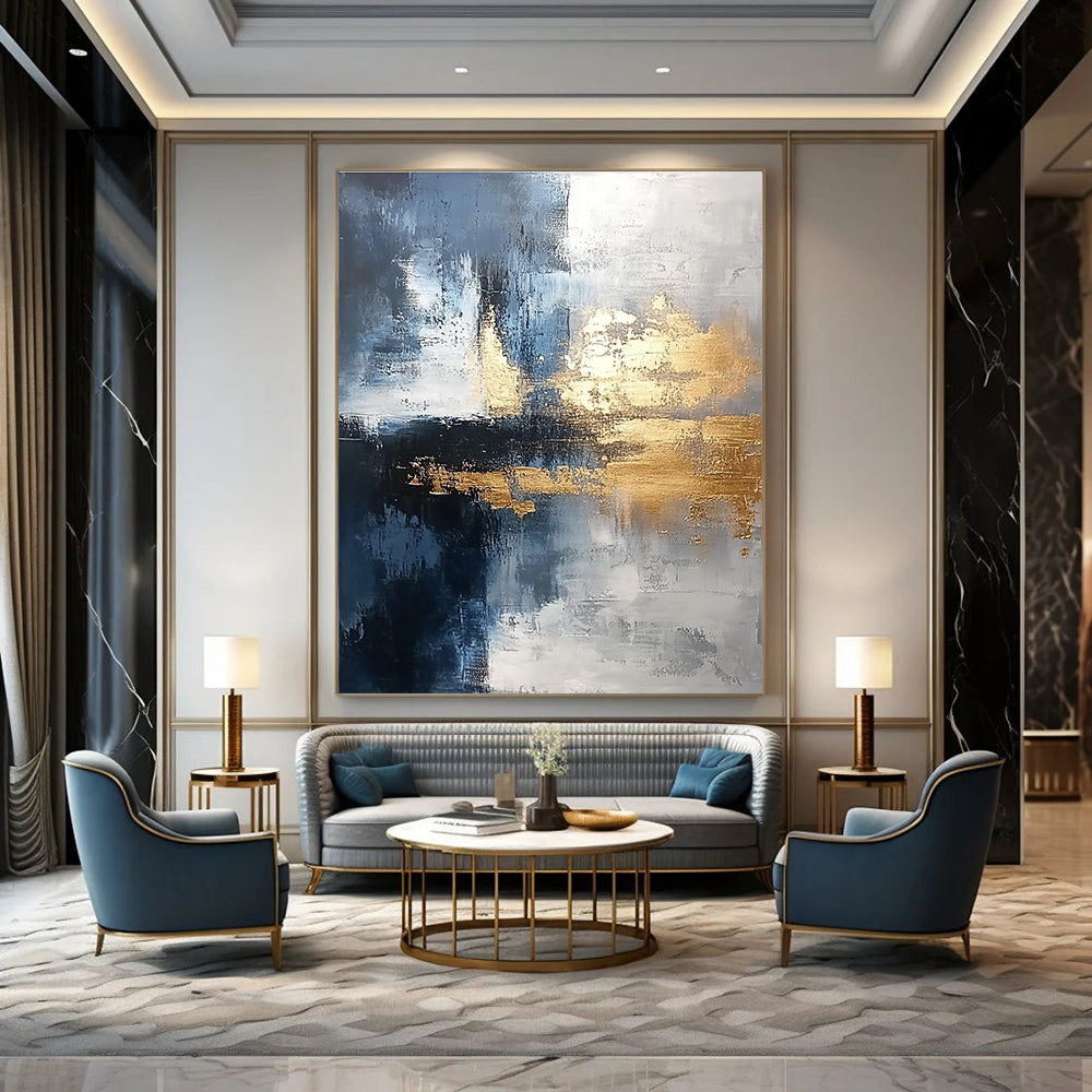Large abstract painting blending silver and gold with gray blue tones and light brushstrokes featuring exquisite details and a unique composition for a calming atmosphere.STSC376