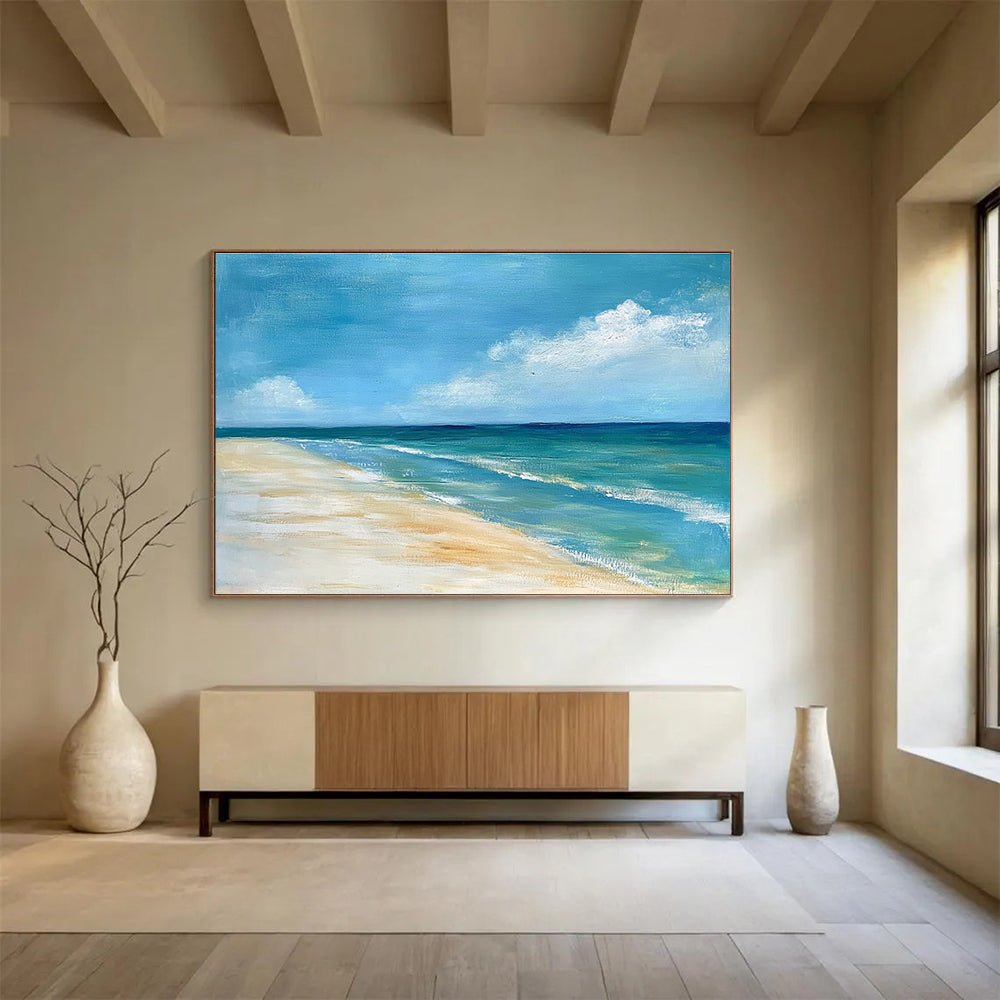 A large abstract painting of the ocean sky and sandy beach in muted blue tones with green accents and soft clouds for a serene ambiance.SC362