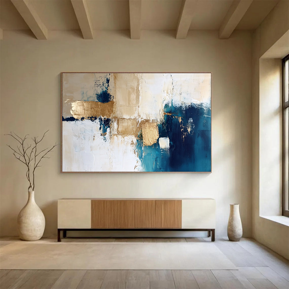 Large abstract painting in blue and gold with white beige and cream tones ideal for modern decor and artistic spaces.SC024