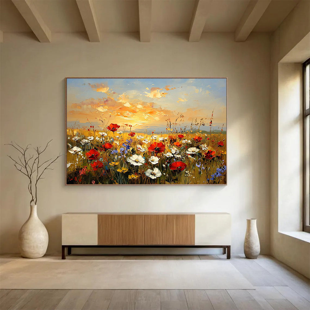 Large abstract painting of a wildflower field at sunset featuring red poppies white daisies and yellow sunflowers in vibrant hues of orange and blue.SC464