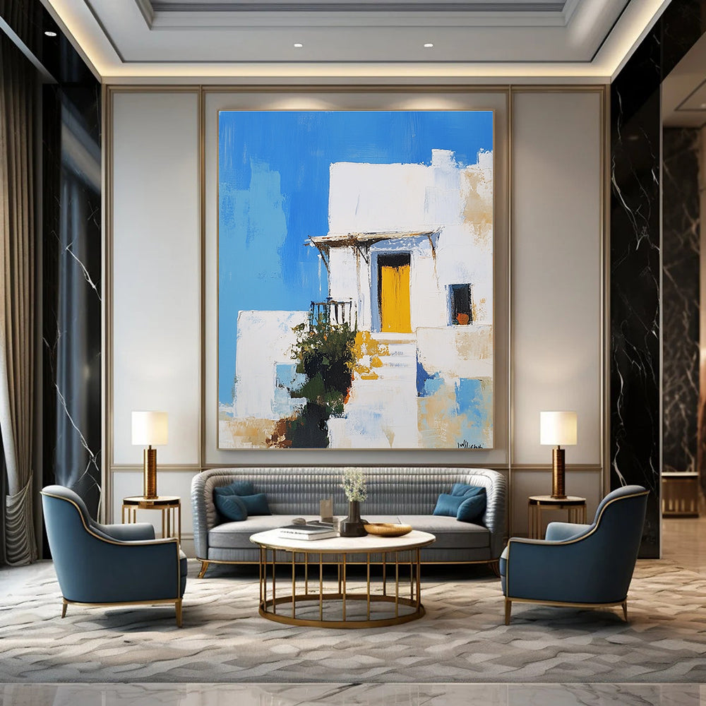 An abstract painting featuring a white Greek-style house with a yellow door against a blue sky inspired by Peter Wileman.STSC1253