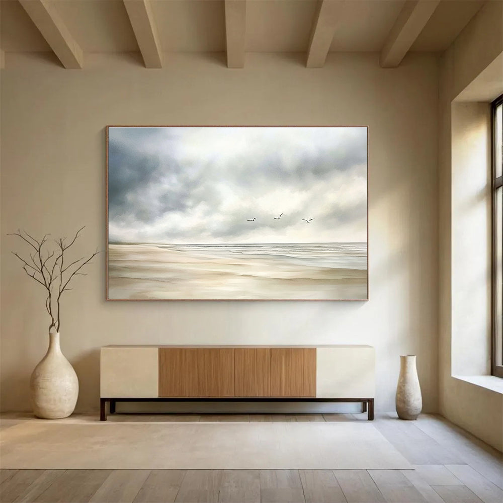 Large abstract watercolor depicting a calm beach scene with muted colors, seagulls in the distance, and a soft cloudy sky on a white background.SC616