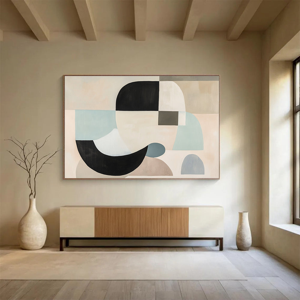 Large abstract painting with white, black, and grey shapes in soft pastel colors featuring geometric forms and a neutral beige background.SC510