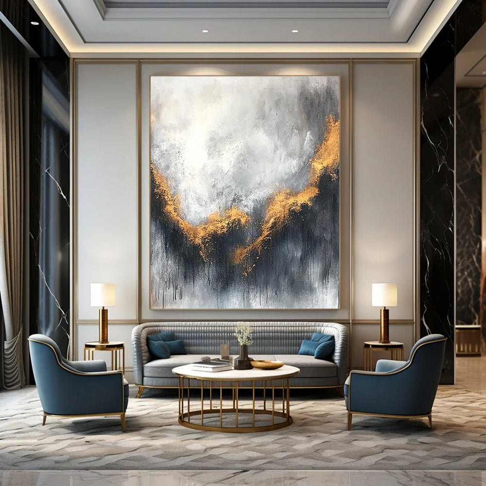Large abstract painting with gray and white background golden accents atmospheric clouds and soft edges evokes calmness and introspection.STSC397