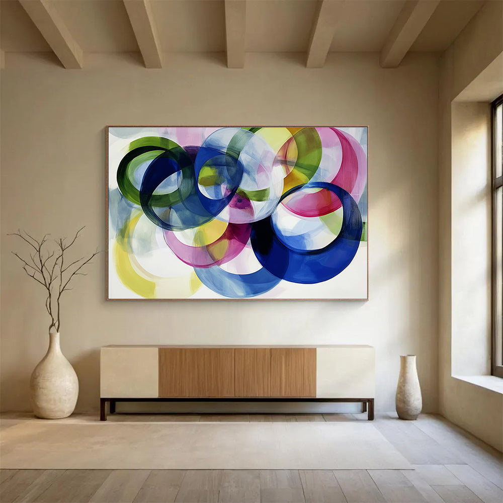 Large abstract painting with colorful overlapping circles on a white background showcasing joyful energy and playful modernity through soft edges and visible brushstrokes.SC525