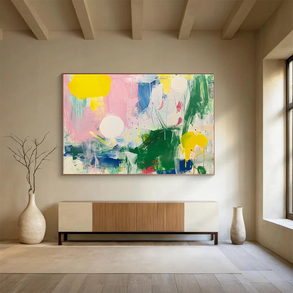 Large abstract painting featuring bright colors with green and pink shapes white circles yellow lines blue lines and light red elements on a white background.SC231