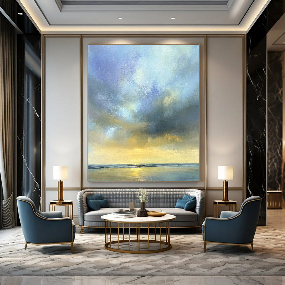 Large abstract oil painting of the sky featuring muted blue light gray and soft clouds over an ocean horizon in beautiful serene colors.STSC201