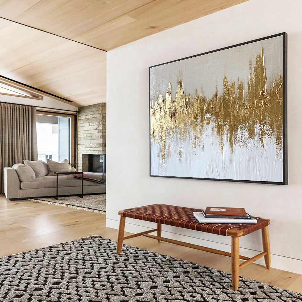 Large abstract painting of a gold and white cityscape with textured canvas and gold foil accents on a neutral background.SC173