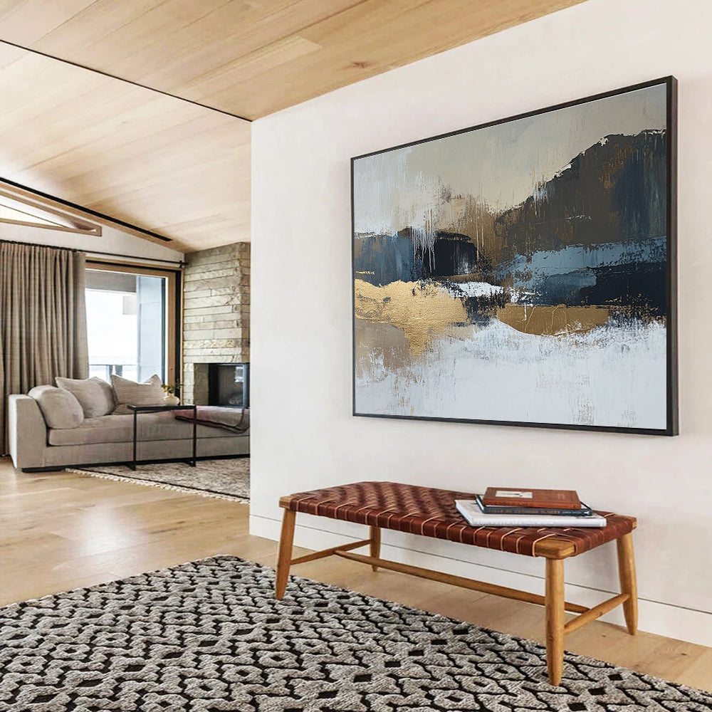 Large abstract painting in beige and dark blue tones with gold accents showcasing a minimalist winter landscape in a neutral color palette.SC226