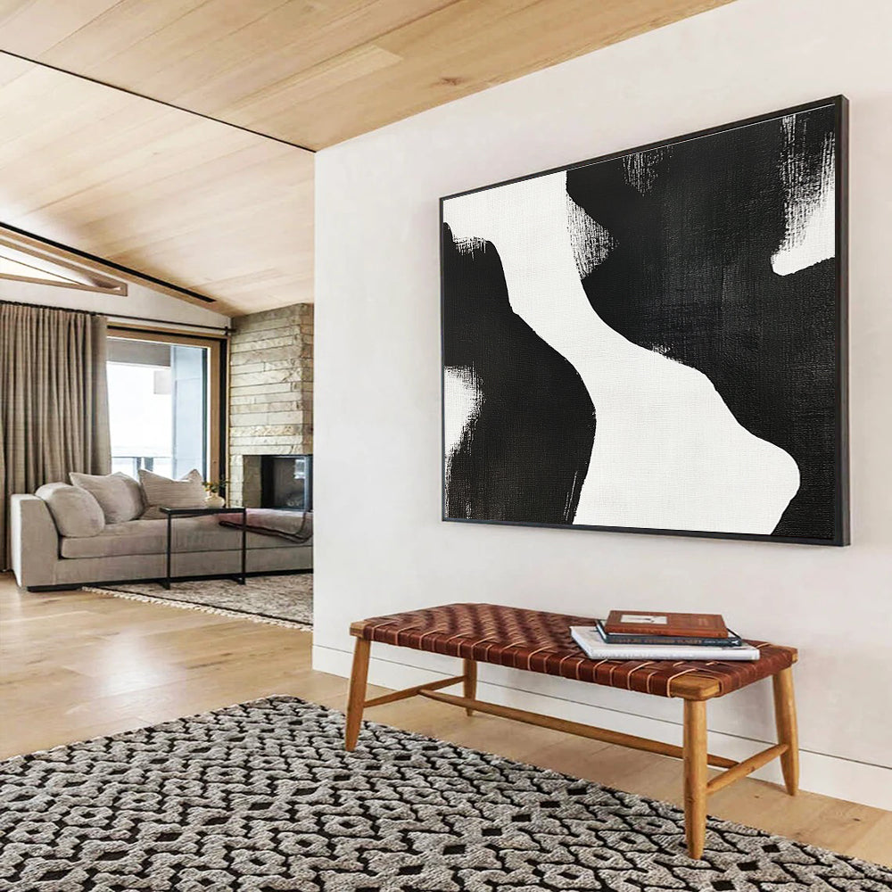 Large abstract painting featuring black and white brush strokes depicting two women’s bodies against a plain white background, showcasing minimalist artistry and tranquil form.SC439