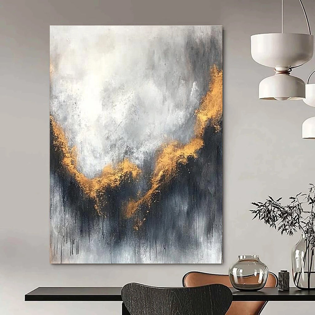 Large abstract painting with gray and white background golden accents atmospheric clouds and soft edges evokes calmness and introspection.STSC397