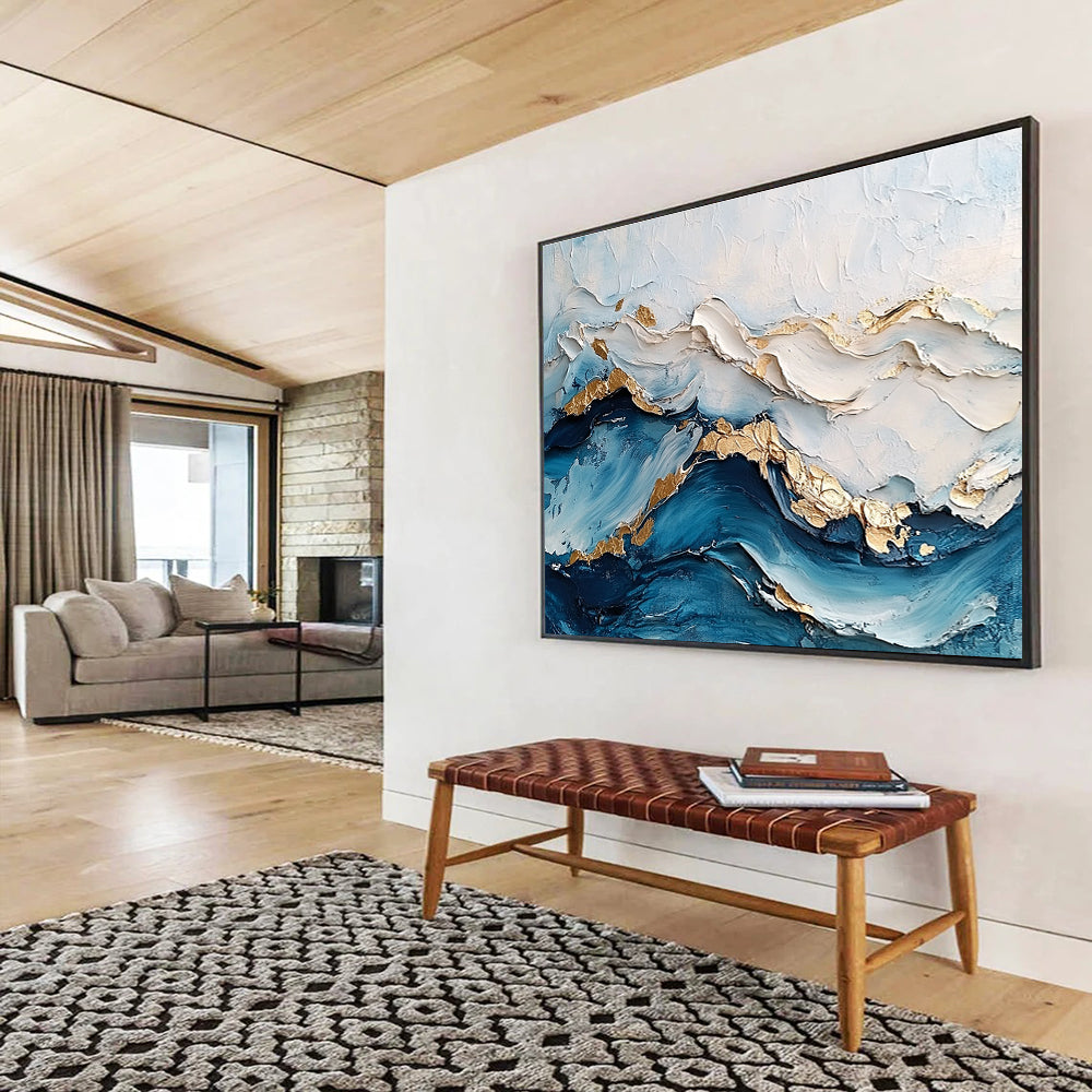 Large abstract painting featuring ocean waves in textured white and blue hues with gold accents for depth and elegance.SC102