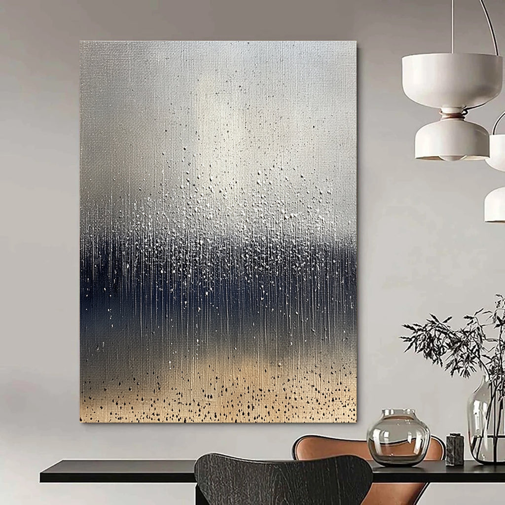 Large abstract painting depicting raindrops on brown soil with a cool gray background and splashing water droplets in dark blue and white tones.STSC1399