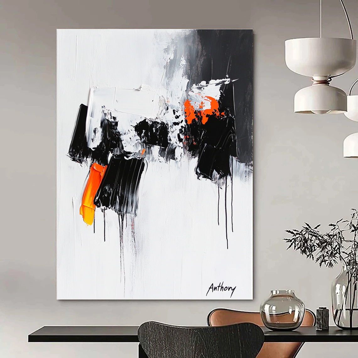 Large abstract painting featuring the word Anthony with black and orange dripping paint thick brush strokes and bold black shapes on a white background.STSC350
