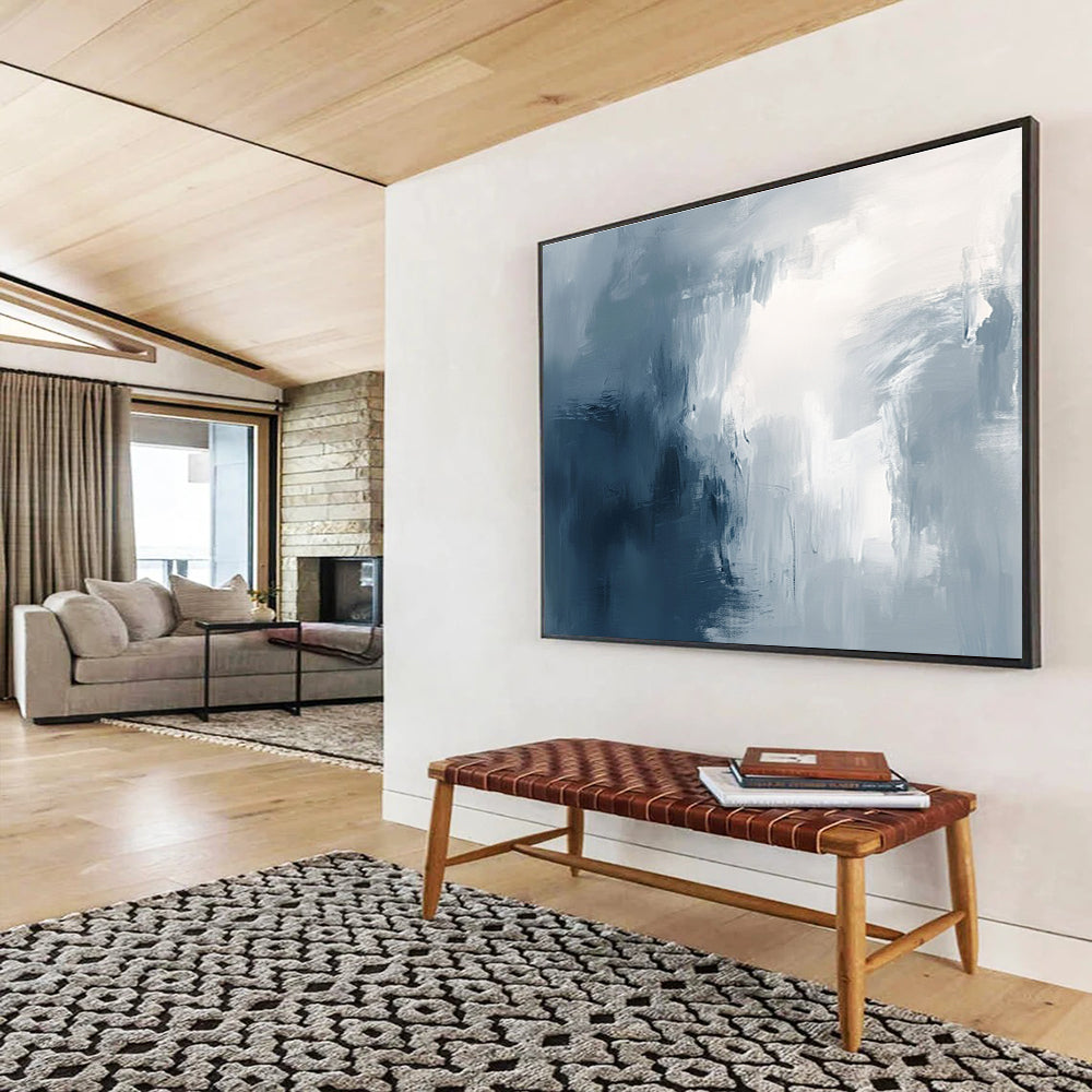 Large abstract painting with broad brush strokes in gray white and navy blue evoking calmness and introspection through soft gradients.SC048
