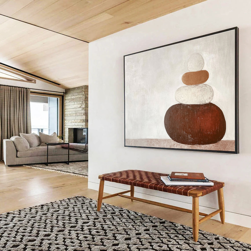 Large abstract painting in earth tones featuring three stacked rocks against a white background creating an elegant contrast.SC495